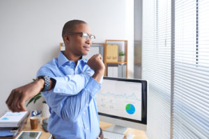 Business man taking a break to stretch and be healthy while working in office