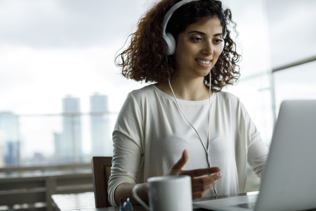 Young woman attending virtual events in her office