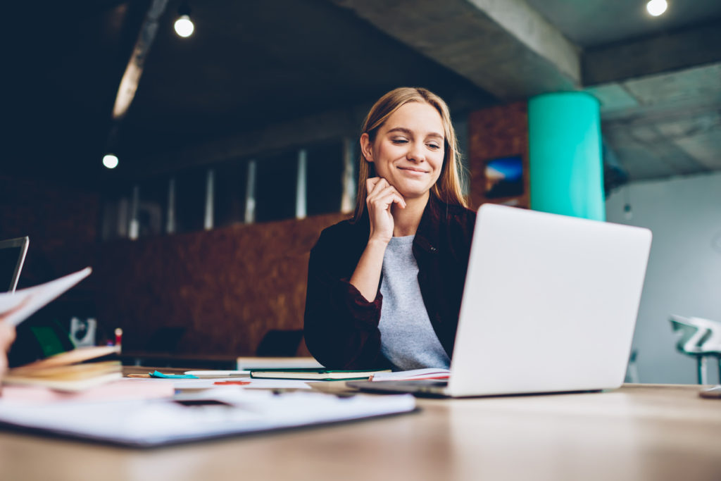 Woman attending virtual event on laptop